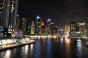 Fototapeta na wymiar DUBAI, UNITED ARAB EMIRATES - NOVEMBER 03, 2018: Night cityscape of marina district with illuminated buildings, blurred view