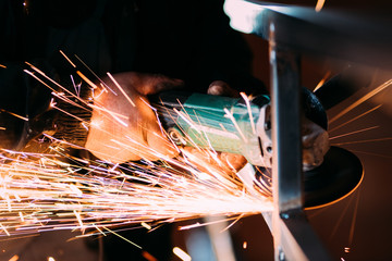 Close up details of electrical rotary angle grinder being used on construction site