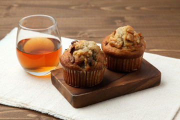 nuts cupcakes muffins with tea isolated on wooden table