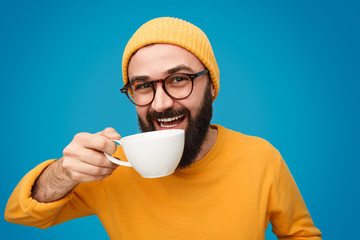 Funny guy drinking hot beverage