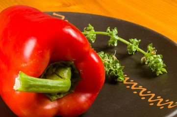 a freshest red paprika, bell pepper in ceramic plate