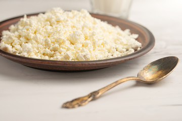 Homemade cottage cheese with raisins and candied fruits, on wooden background