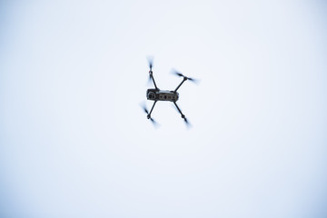 Dron overlooking the landscape in the background of a forest and village during a landing maneuver on a brick platform