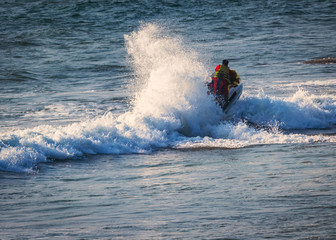 riding a jet ski / wave runner in Goa sea, wearing safety jackets. Baga beach.  water sports famous...
