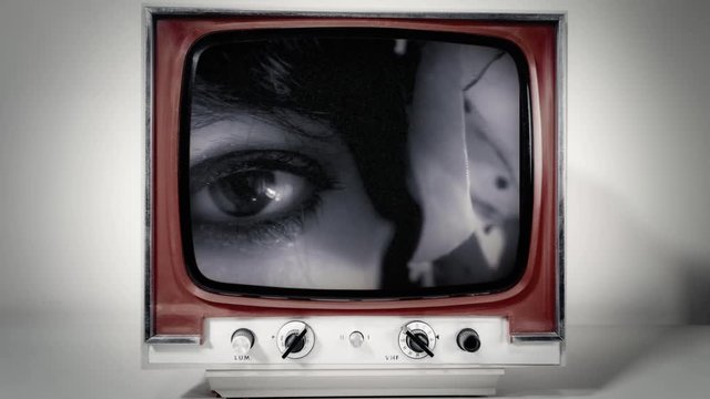 A retro vintage TV showing: a woman's eye looking in camera, intense black and white colors (like a film noir), macro shot.