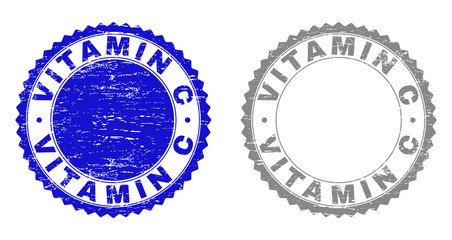 Grunge VITAMIN C stamp seals isolated on a white background. Rosette seals with grunge texture in blue and grey colors. Vector rubber watermark of VITAMIN C label inside round rosette.