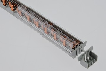 Gray plastic electric terminal bar with copper contacts and plastic transparent cover, , light...