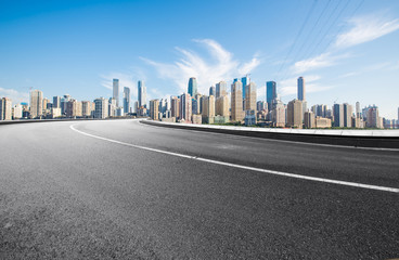 The expressway and the modern city skyline are in Chongqing, China.