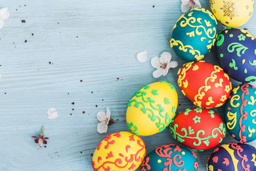 Easter eggs and spring flowers on wooden background