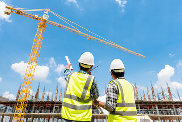 Civil engineer checking work with walkie-talkie for control and management in the construction site...
