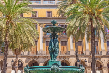 Ancient fountain with sculptures on  square in Barcelona