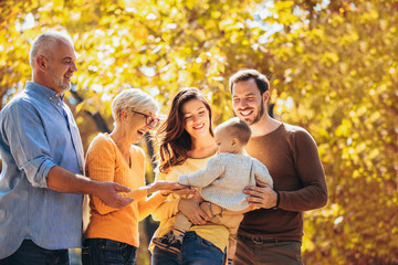 Multl generation family in autumn park having fun