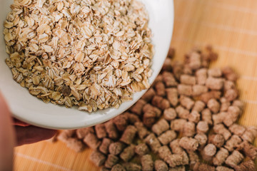 Oatmeal and bran in a white plate. Slimming diet