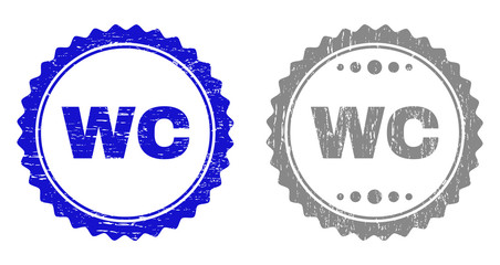 Grunge WC stamp seals isolated on a white background. Rosette seals with distress texture in blue and gray colors. Vector rubber stamp imprint of WC label inside round rosette.