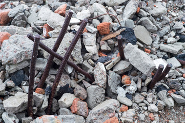 The rebar sticking up from piles of brick rubble, stone and concrete rubble. Remains of the destroyed building