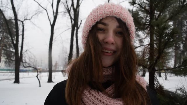 Cute portrait of brunette girl in hat. Winter park.