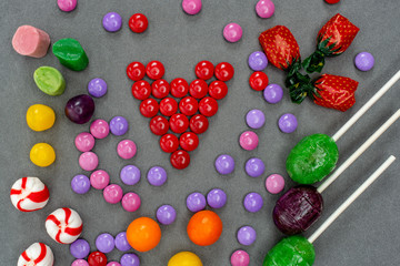 Candies arranged on grey background suitable for multiple applications