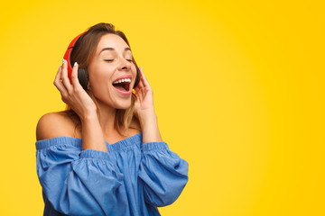 Young woman listening to music and singing along