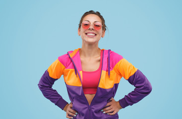 Cheerful pretty hipster girl in colorful jacket