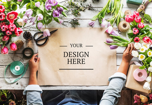 Kraft Paper on Table Surrounded by Flowers Mockup