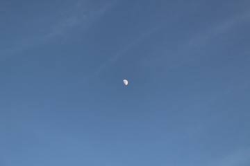 The moon in the blue sky