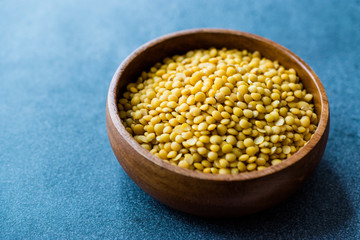 Yellow Lentils in Wooden Bowl.