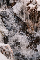 frozen little water stream in winter landscape