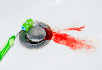 blood in the sink and toothbrush, concept problem with teeth