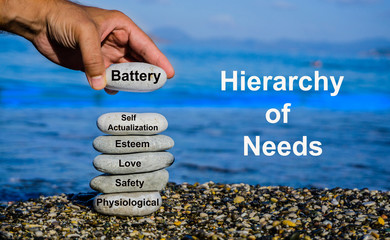 Mobile smart phone and internet addiction concept. Man adding stone to pebble tower.