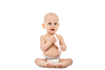 smiling funny baby getting a diaper change. with wipe isolated on a white background. concept...