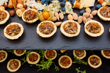 snacks of tartlets with different fillings and nuts