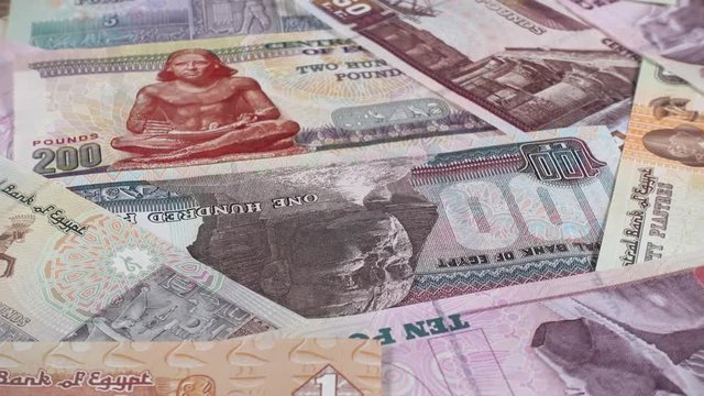 Egypt currency pound notes slow rotating. Low angle. Egyptian money. 4K stock video footage