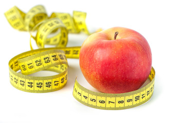 Red apple with measure tape on white background, healthy diet