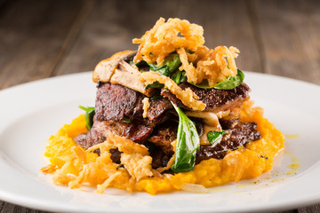 Grilled steak with mashed vegetables