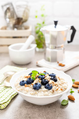 Oatmeal with fresh blueberry, almond nuts and honey for breakfast