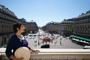Femme appuyée au balcon extérieur de l'Opéra Garnier Place de l'opéra à Paris