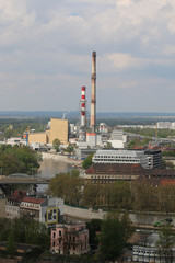 Obraz premium Spring day in Wroclaw. View from the tower of church of St. Elisabeth to the Nadodrze, outskirts. Visible buildings, tenements, bridge, Odra river, blocks of flats, heat and power station, chimneys.