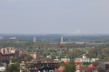 Spring day in Wroclaw. Wiew from the church tower of St. Elisabeth to the outskirts, bridges, cranes, green areas. Wrocław, Breslau, Lower Silesia, Dolny Śląsk, Polen, Poland, Polska. 