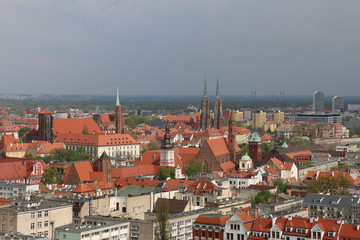 Fototapeta na wymiar Warm, spring day in Wroclaw. View from the tower of the church of Saint Elizabeth to the Cathedral, Ostrów Tumski, old town, churches, Odra River, blocks of flats, the Olympic Stadium, dormitories