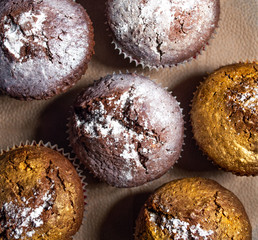 delicious golden silver muffins, handmade, baking with powdered sugar on a paper napkin, top view