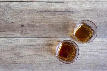 Glass of whiskey, bourbon on a wooden background. Scotch. Alcoholic drink
