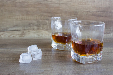 Two glasses of whiskey, bourbon in a glass. Alcoholic drink. Whiskey with ice
