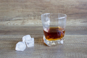 Glass of whiskey, bourbon on a wooden background. Scotch. Alcoholic drink