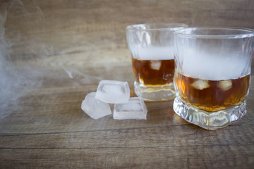 Two glasses of whiskey, bourbon in a glass. Alcoholic drink. Whiskey with ice