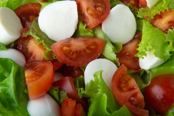 healthy salad of mozzarella, iceberg lettuce and fresh juicy cherry tomatoes, top view, menu option, salad composition