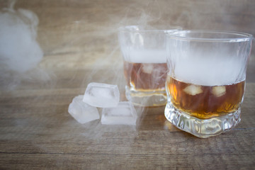 Two glasses of whiskey, bourbon in a glass. Alcoholic drink. Whiskey with ice