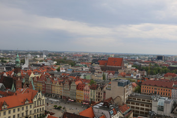 Warm, spring day in Wroclaw. View from the church tower of St. Elisabeth to the town hall, market square, church, old town, buildings, tenement houses, blocks of flats. Wrocław, Breslau, Poland