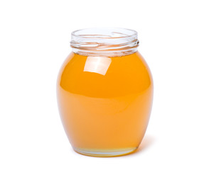 honey dipper and honey in jar on white background