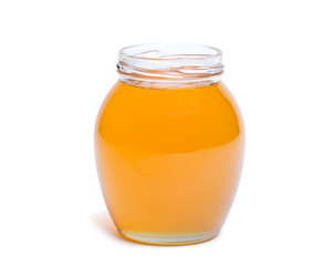 honey dipper and honey in jar on white background