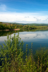 Fototapeta na wymiar Spring panorama of a forest lake